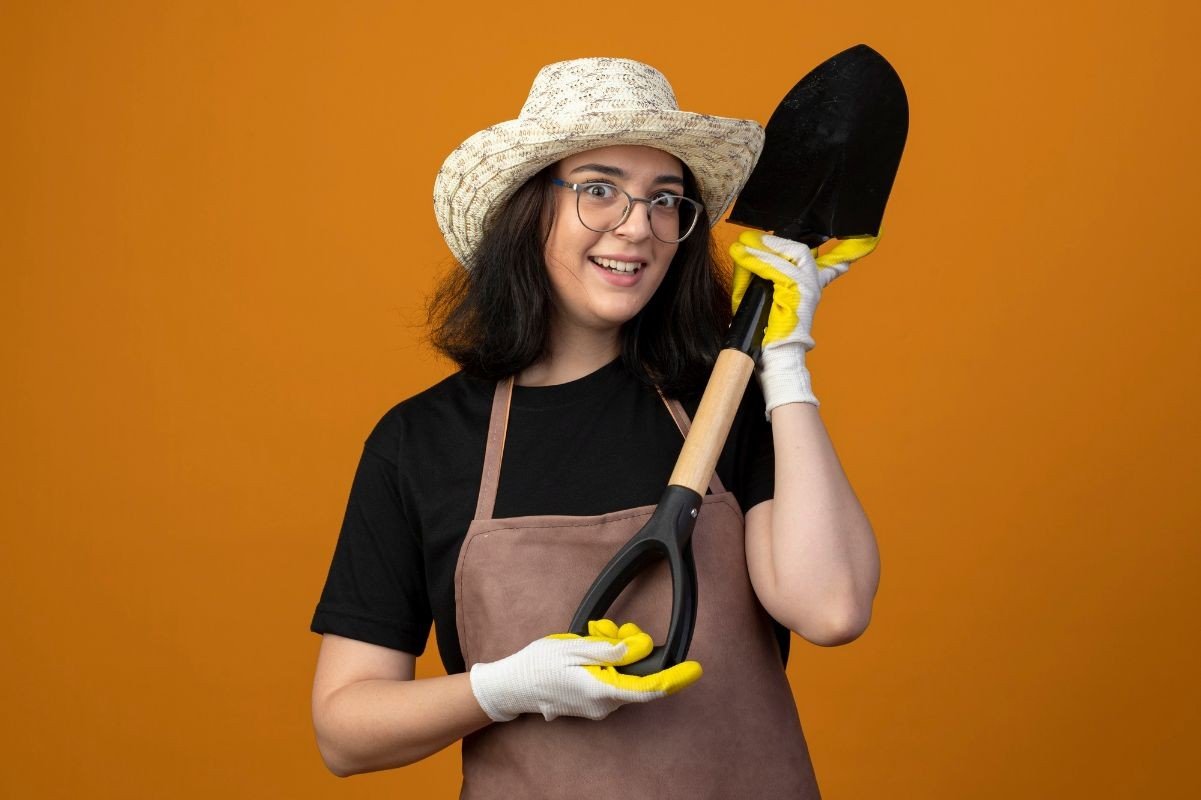 mulher segurando pa de jardinagem